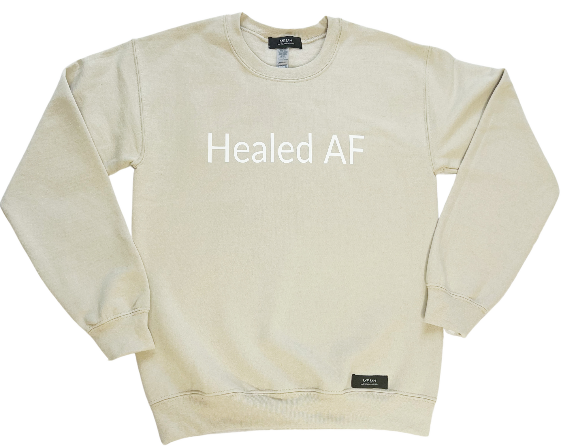 Long sleeve cozy sand colored crewneck sweater with white vinyl lettering with phrase “Healed AF”