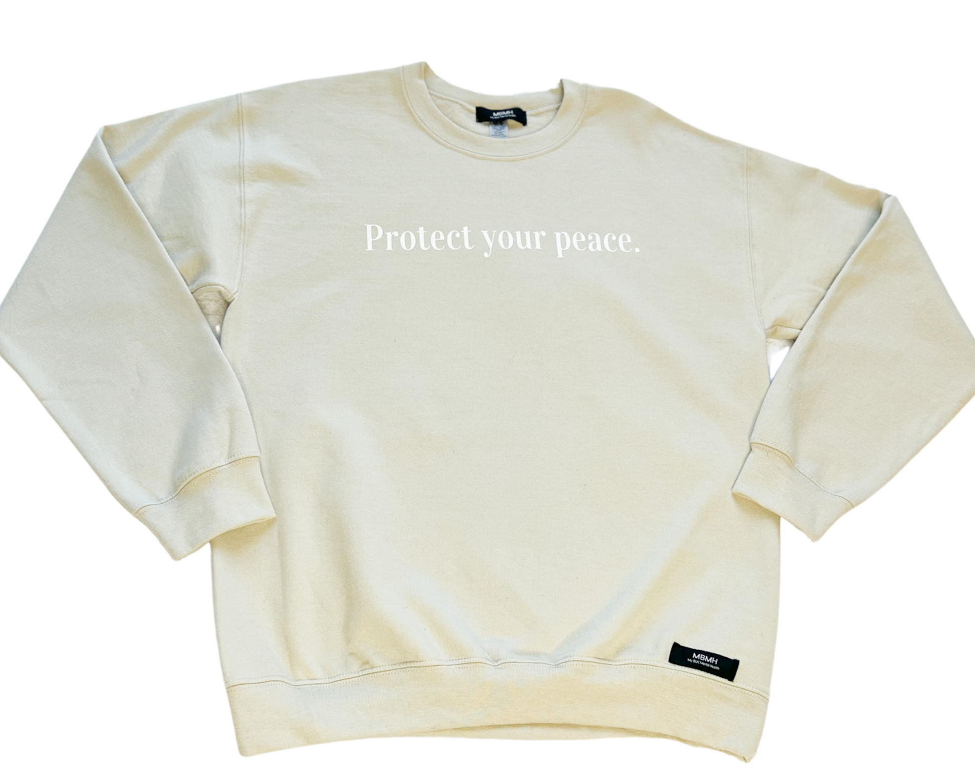 Long sleeve cozy sand colored crewneck sweater with white vinyl lettering with phrase “Protect your peace.”